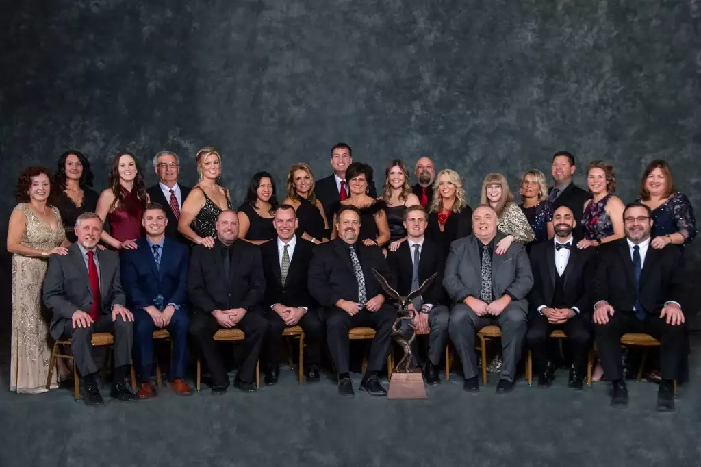 Owner and President Andy Royalty (seated, center) is flanked by Royalty Roofing executives and their significant others at the Duro-Last 2022 National Sales Seminar.